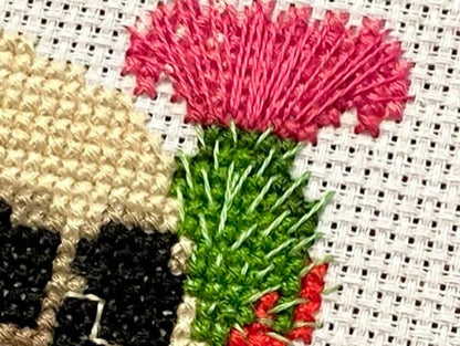 Cross stitch Skull with a bleeding thistle close up